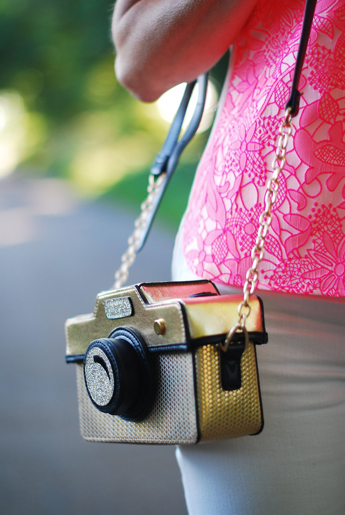 Camera bag and neon pink top