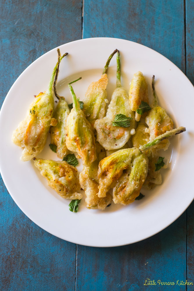 Ricotta stuffed squash blossoms are a summer staple. Seasoned with herbs, lemon zest and gently fried to perfectly golden brown.