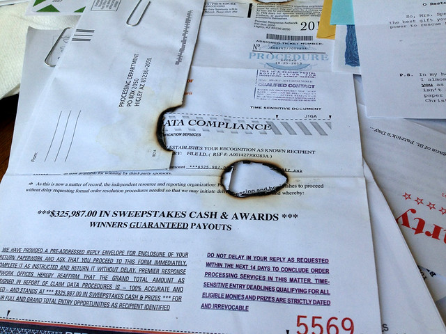 Junk Mail with a cigarette burn