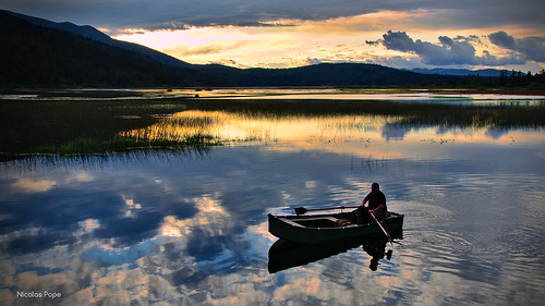 sunset lake fisherman slovenia cerknica
