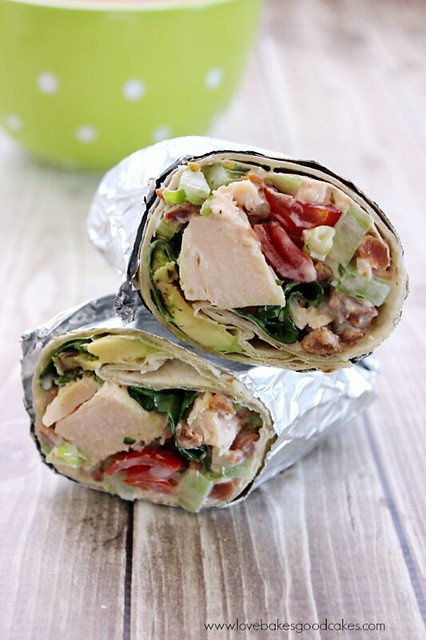 Bacon Lettuce Avocado Tomato Chicken Salad Wraps cut in half stacked on top of one another.