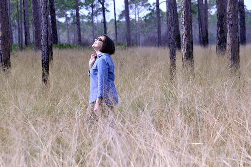 Betsie Rothermel, restoration ecology research director at Archbold Biological Station, strolls through an easement she is restoring. NRCS photo.