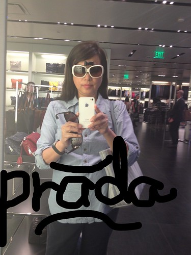 trying on sunglasses at the Prada store