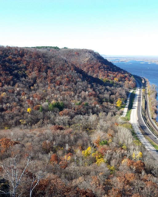 looking down from a cliff at trees, Highway 61 and the Mississippi River