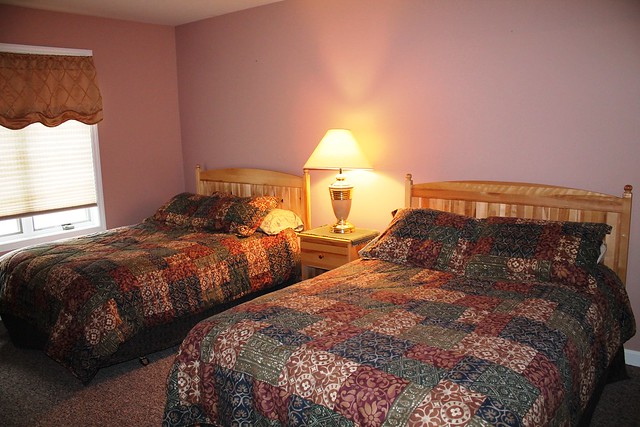 Guest bedroom with two double beds, full closet and flat screened TV;