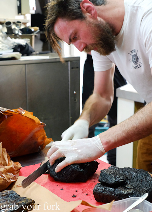 Chris Terlikar, executive chef, carving the smoked brisket at Bluebonnet BBQ, Collingwood