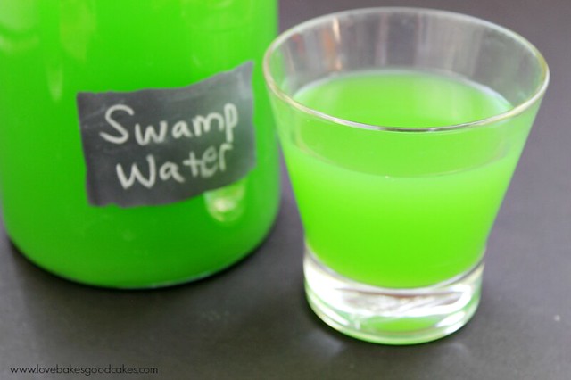 Swamp Water Drink in clear glass with pitcher.