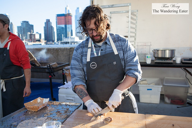 Chef Matt Lightner of Atera slicing up his barbecued chicken with Alabama-style white sauce
