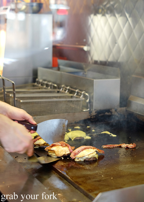 Flipping burgers on the grill at Huxtaburger, Collingwood