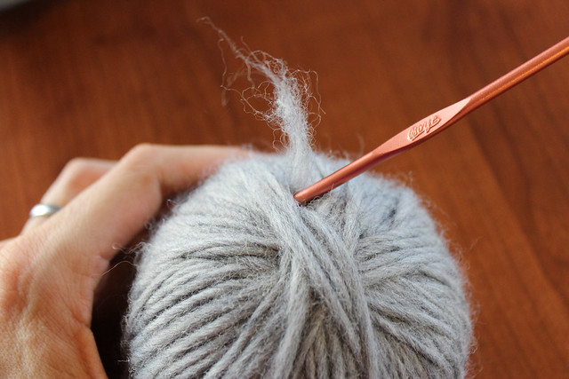 Tuck excess yarn into the ball carefully.