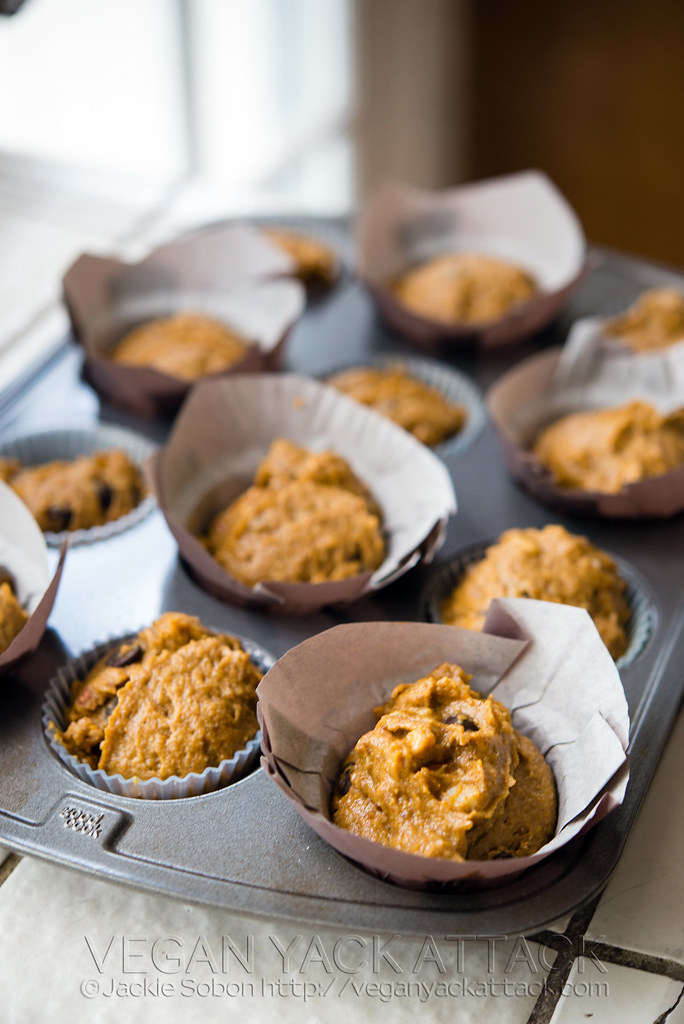 Several Pumpkin Banana Nut Muffins with chocolate chips in a muffin pan before baking