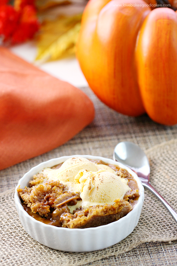 Slow Cooker Pumpkin Spice Lava Cake in a white bowl with a spoon.