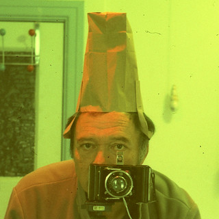 reflected self-portrait with Wirgin Baky camera and tall hat (square crop)