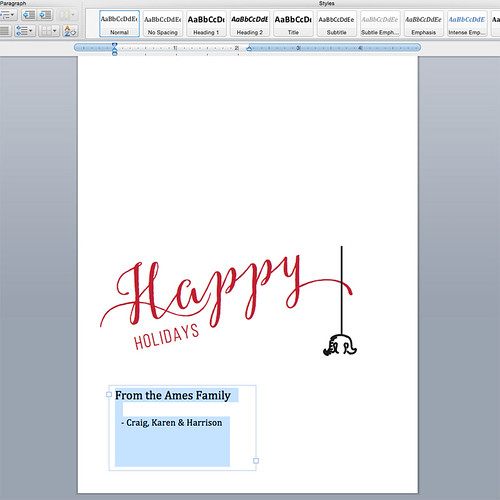 designing customizable holiday card template on computer, screen view