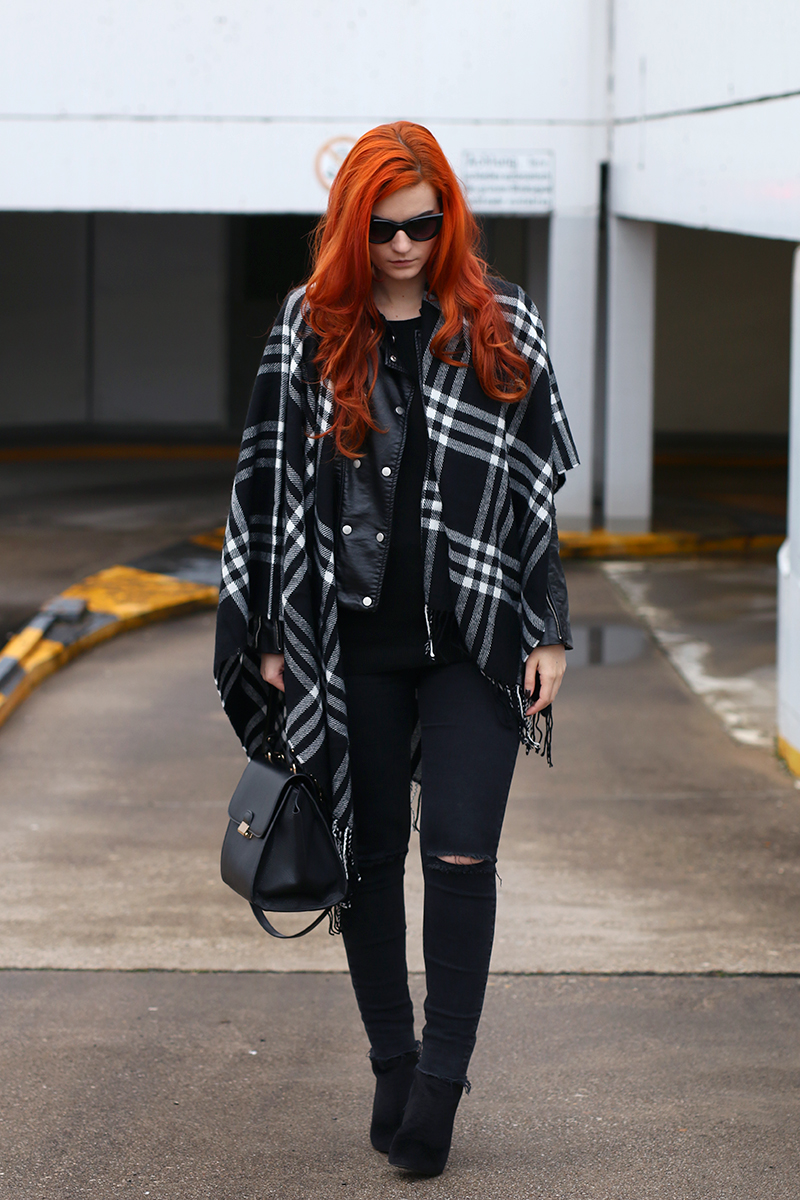 Black leather jacket and checked poncho with trapeze bag