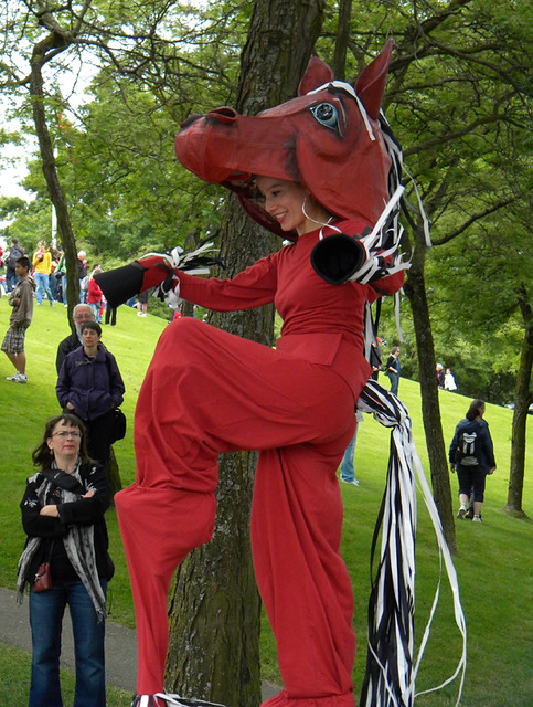 A red horse costume on stilts on Canada Day on Granville Island in Vancouver, BC