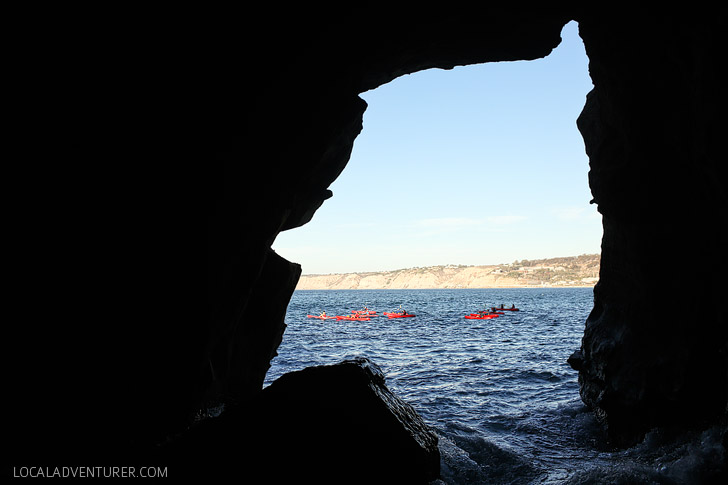 Kayakers near the Sunny Jim Cave - A hidden and historic La Jolla attraction.