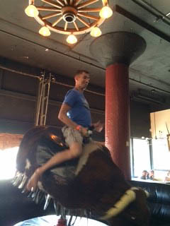 Frank riding the mechanical bull at the Bourbon Barrel