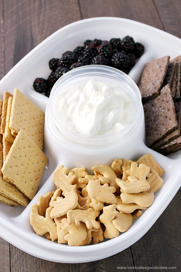 Appetizers and dip in an appetizer tray.