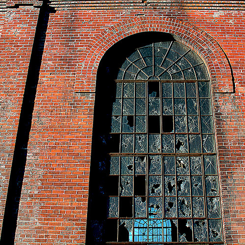fourcotts square olympus omd em5 mkii evanston wyoming usa railroad roundhouse brick glass shattered blue sky distant black red