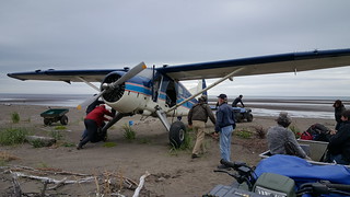 Giving the plane a push back out to the beach runway