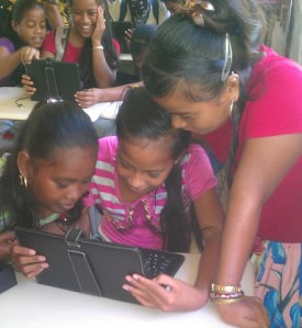 Students work on a laptop, as part of a 2014 grant to iSolutions in Micronesia. 