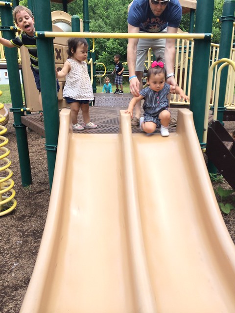 Mirei and Lily going down the slide together.