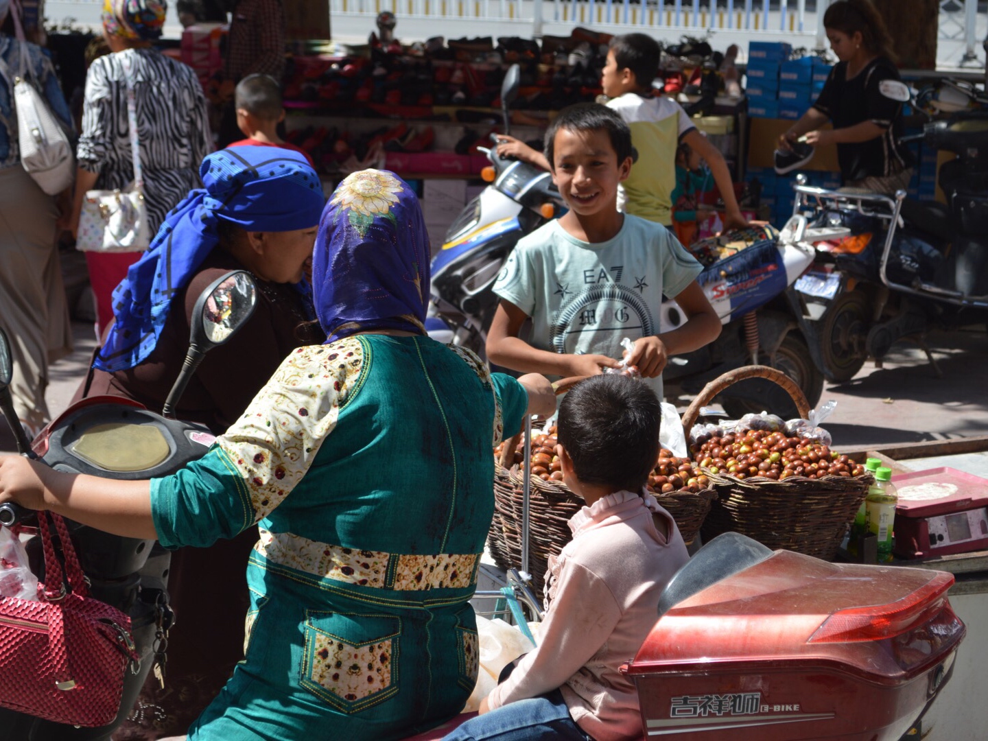 Smart kid selling nuts at a street market in Kashgar