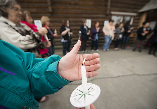 A participant in a candlelight vigil to remember victims of sexual assault shields her tiny flame from the wind outside Tyotka's Elder Center in Old Town Kenai. After a long moment of silence, participants took turns honoring family, friends and themselve