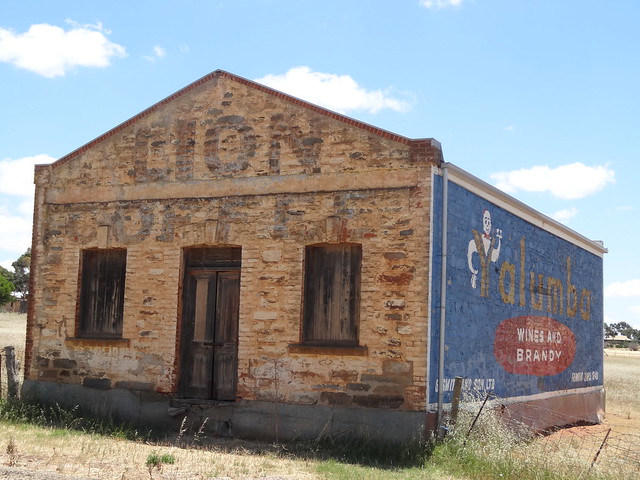 Kapunda. Old stone store  on edge of the town with quaint old advertising. Lions Coffee and Yalumba wines.
