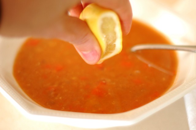 Squeezing meyer lemon into the red lentil soup with chili paste by Eve Fox, the Garden of Eating, copyright 2015