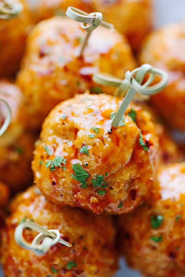 close up of firecracker chicken meatballs on appetizer sticks