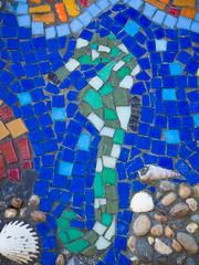A picture or pattern produced by arranging together small colored pieces of hard material, such as stone, tile, or glass.