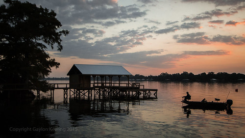 man sunrise geotagged pier boat fishing dock louisiana lakebruin