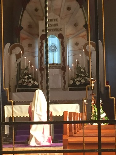 nun prays at the altar