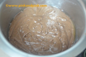 Pouring the cake batter in the cooking pan for eggless vegetarian chocolate cake recipe