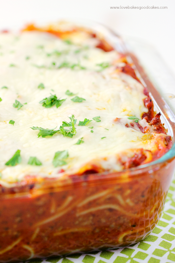 Cheesy Baked Spaghetti in a clear baking dish close up.