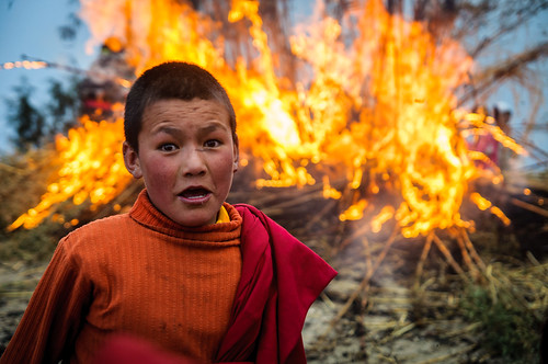 arunachalpradesh asia bonfire boy buddhism expression fire india indiane monastery monk people red religion tawang torgya