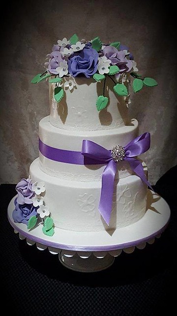 Purple, lavender and white wedding cake. All flowers were handmade from Creative Cakes by Lyndie