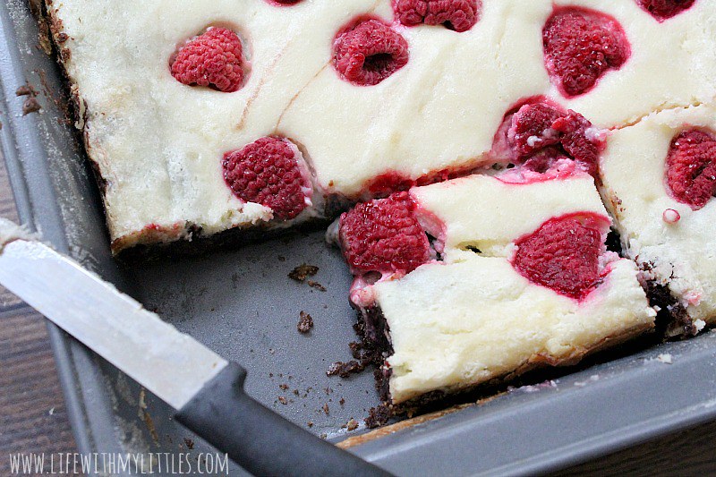 These raspberry cheesecake brownies are so easy, and so divine. Thick chocolate chunk brownies topped with homemade cheesecake and fresh raspberries! Everyone will be begging you for the recipe!