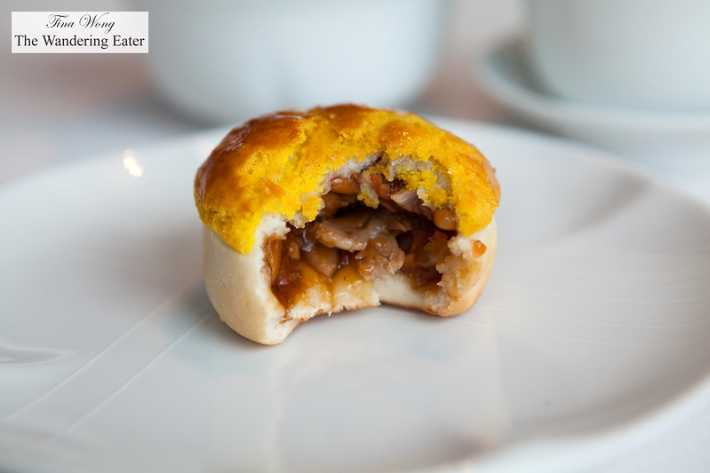 Cross section of baked barbecued pork bun with pine nuts