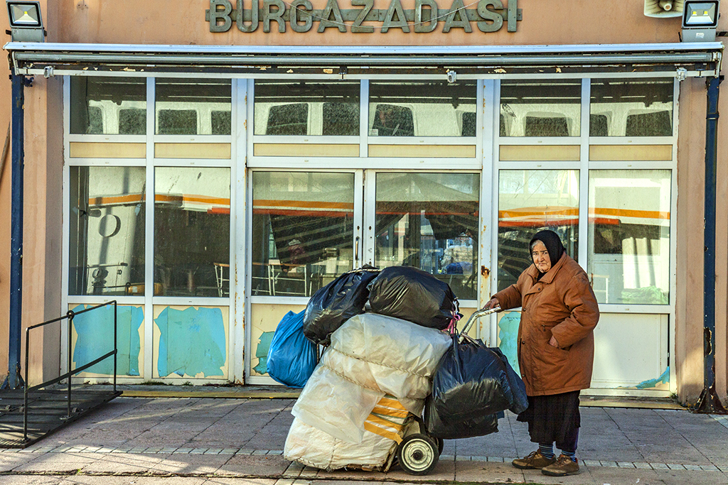Woman with much stuff waiting for ferry--Burgazada