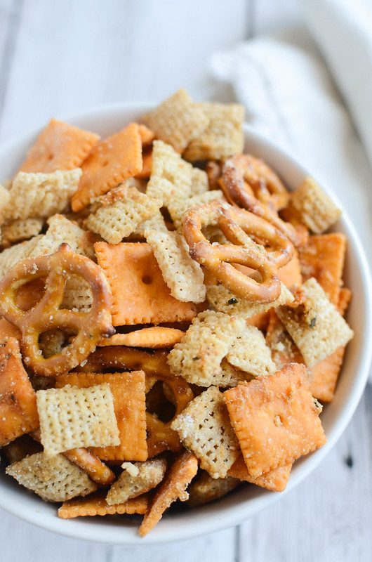 Cheesy Ranch Chex Mix - Chex cereal, crackers, and pretzels coated in a delicious parmesan and ranch seasoning. Seriously addictive!