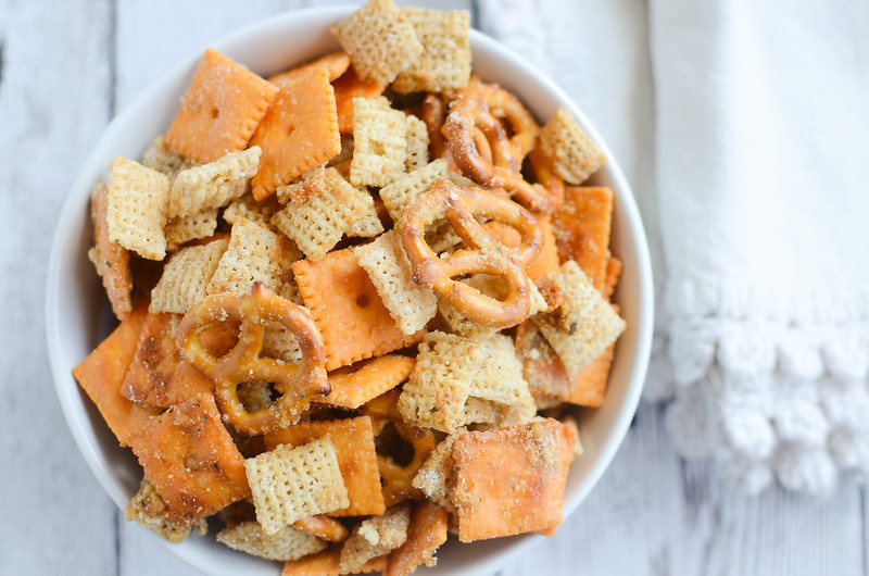 Cheesy Ranch Chex Mix - Chex cereal, crackers, and pretzels coated in a delicious parmesan and ranch seasoning. Seriously addictive!