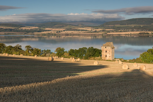 benwyvis blackisle craigcastle cromartyfirth highlands scotland castle shadows clouds landscape water autumn sunrise field agriculture heritage barley stubble hay straw bales trees